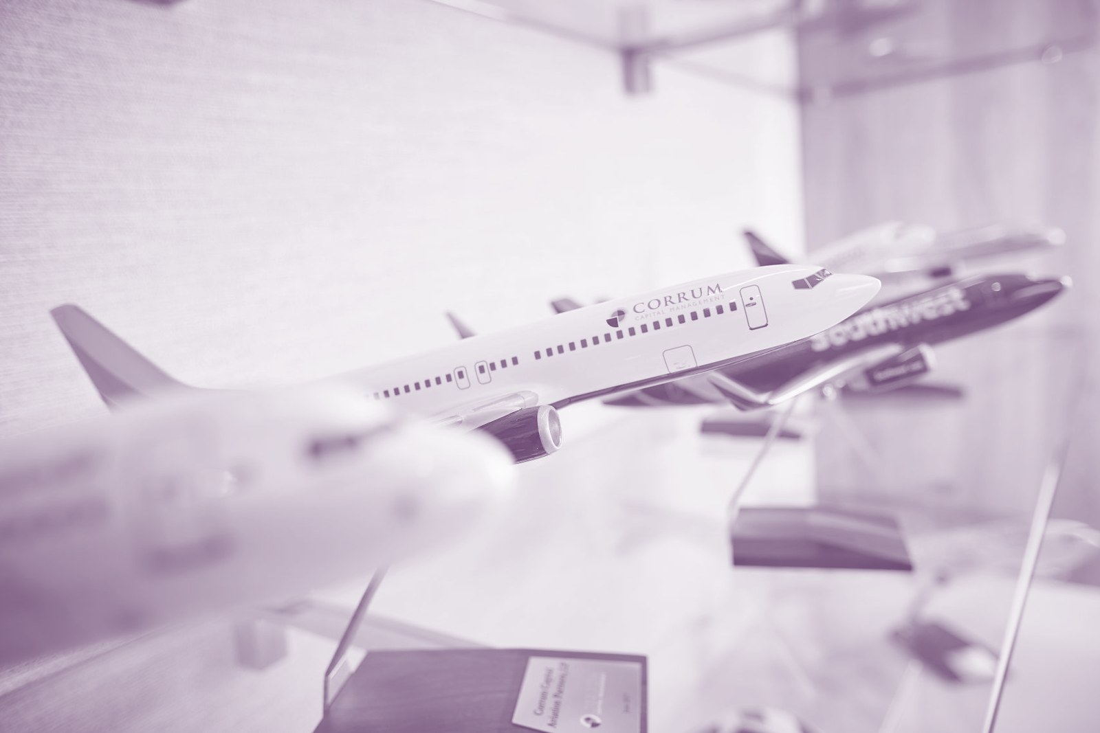 A Corrum-branded model aircraft among a display of narrowbody airline models.